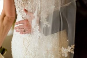 Orlando groom softly embraces his bride's lovely waist.