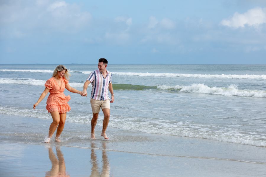 Engaged couple walking on the beach