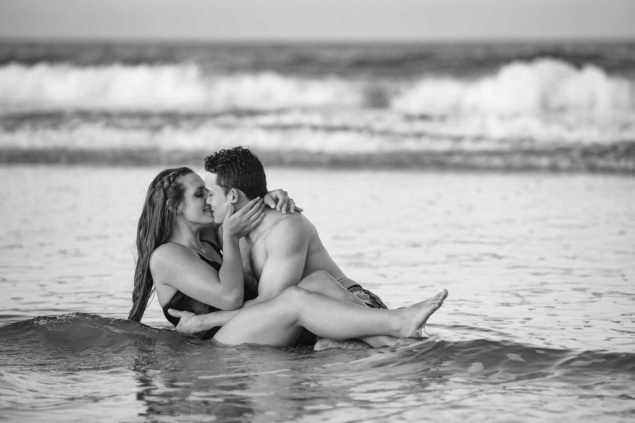 engaged couple in the ocean