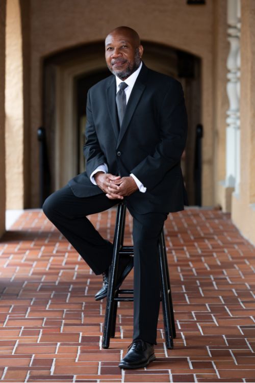 Orlando Wedding Photographer Sterling sitting on a bench